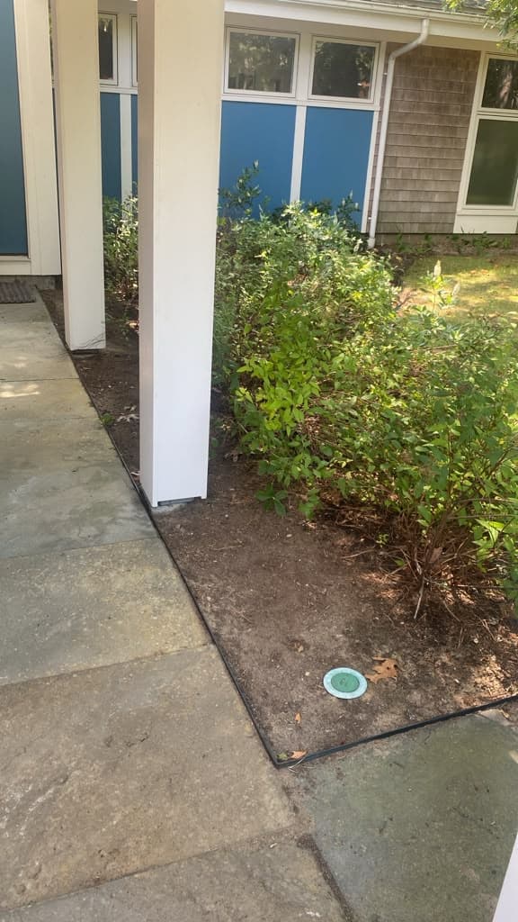Clean edging along a stone walkway and planting bed
