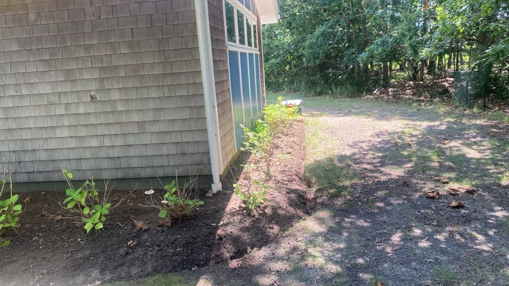 Freshly mulched planting bed near a home entrance